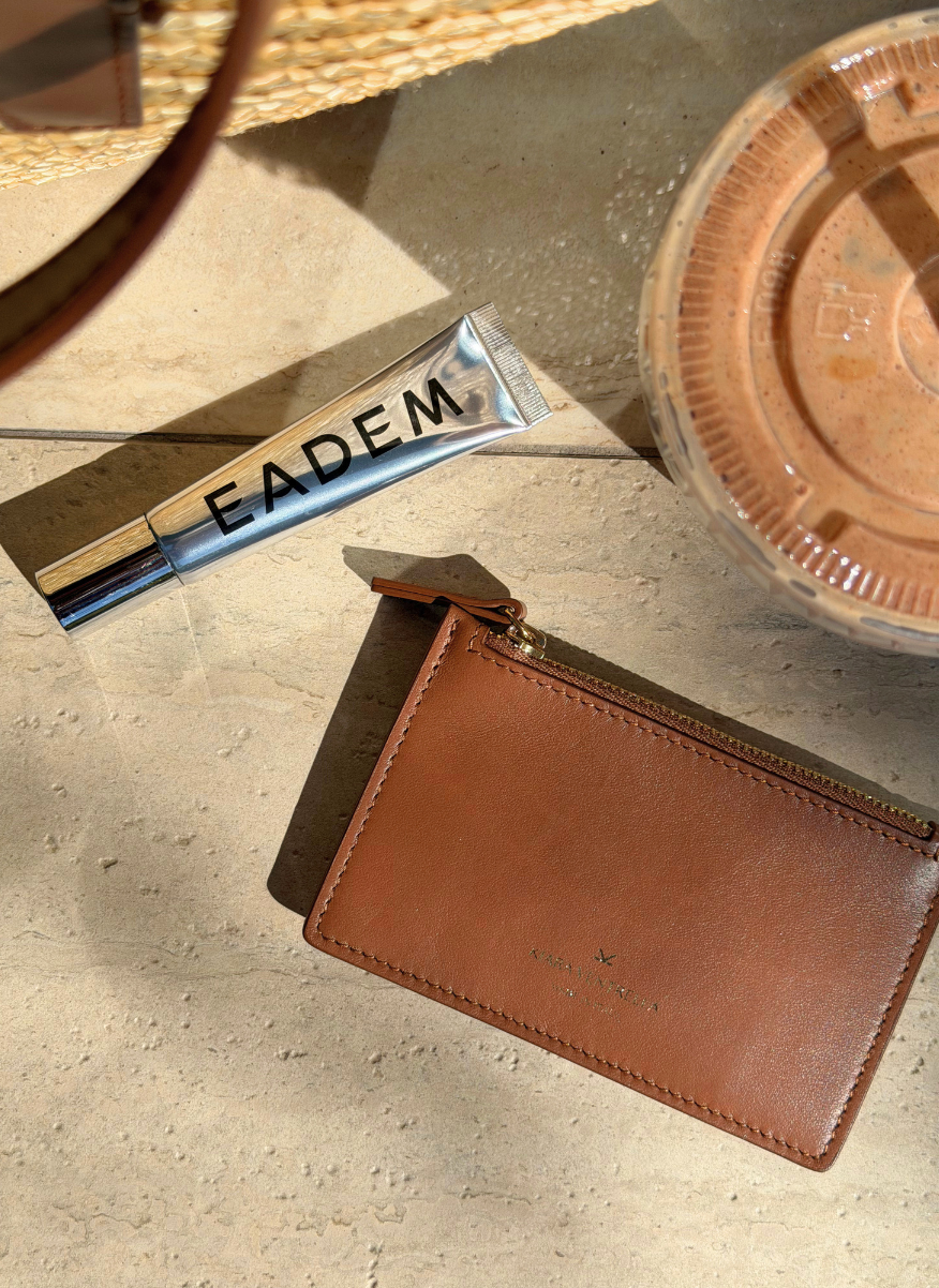 Lifestyle: Card Case Slim Smooth Brown leather (Chestnut), zip closure, ice coffee, Eadem Lipgloss. K Kiara Ventrella Gold Foil Logo.