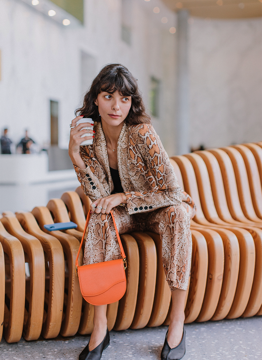 Ella Wave Saddle Bag in Pebbled Orange worn as a shoulder bag