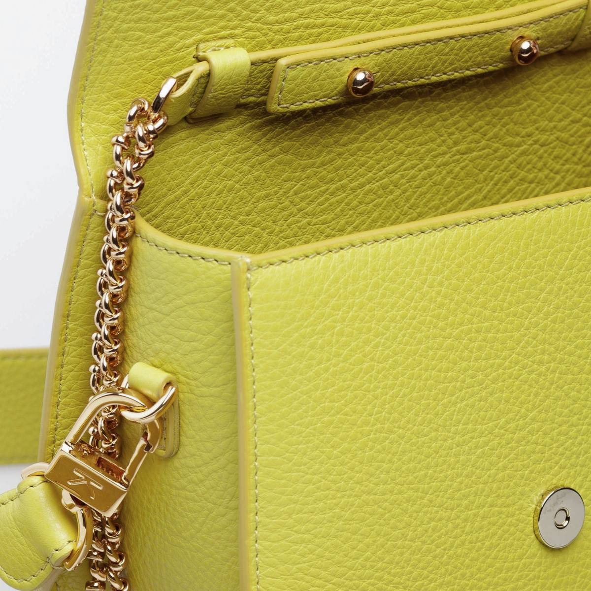 Interior of Ella Wave Saddle Bag showing microsuede lining and open pocket. Removable Crossbody chain strap and removable leather shoulder strap. (Pebbled Chartreuse Leather, Yellow-Green)