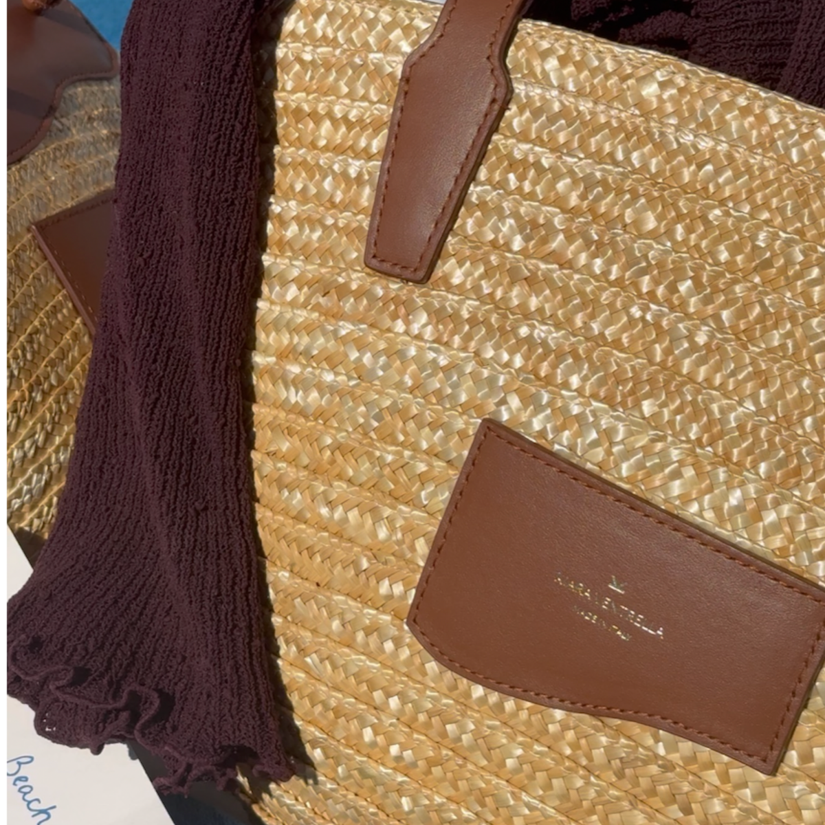 Lifestyle: Close up, Large Straw Marea Tote in Chestnut Brown (Smooth brown leather). 